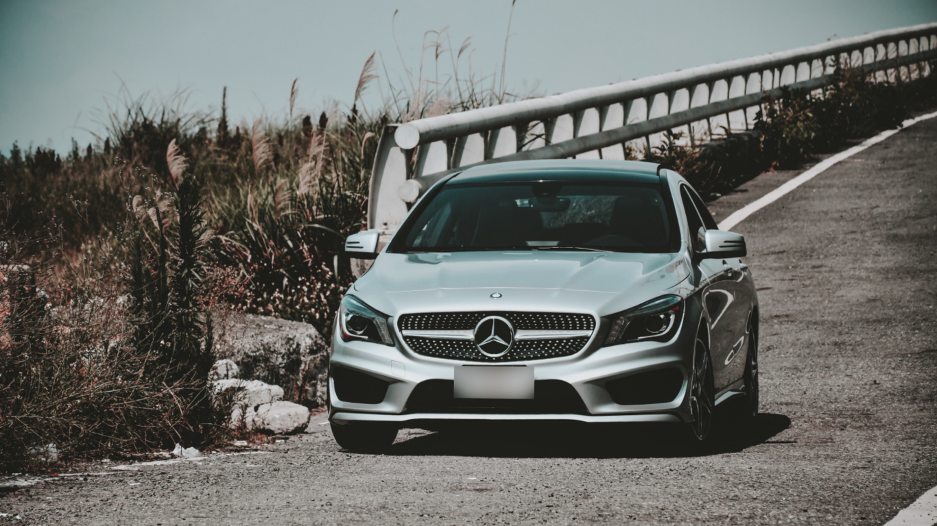 White Mercedes Benz c Class Parked on Gray Sand During Daytime. Wallpaper in 1366x768 Resolution