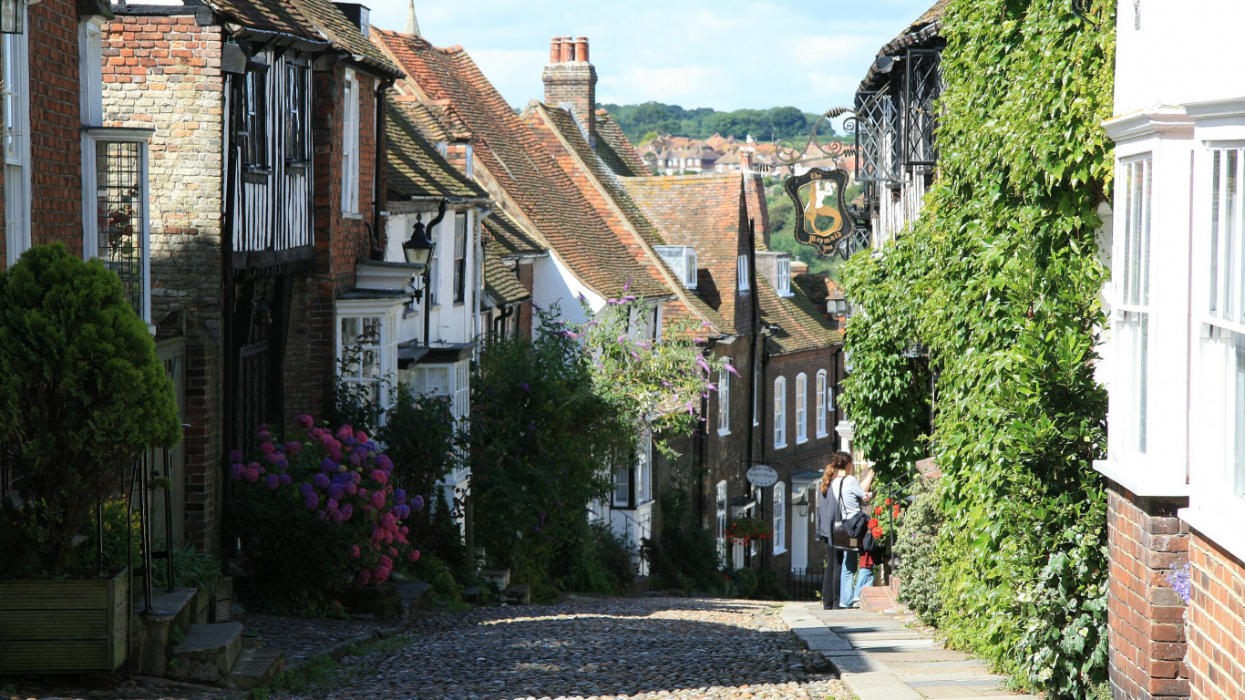 People Walking on Street Between Houses During Daytime. Wallpaper in 1366x768 Resolution