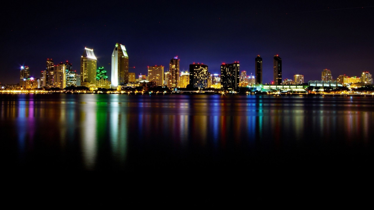 City Skyline Across Body of Water During Night Time. Wallpaper in 1280x720 Resolution