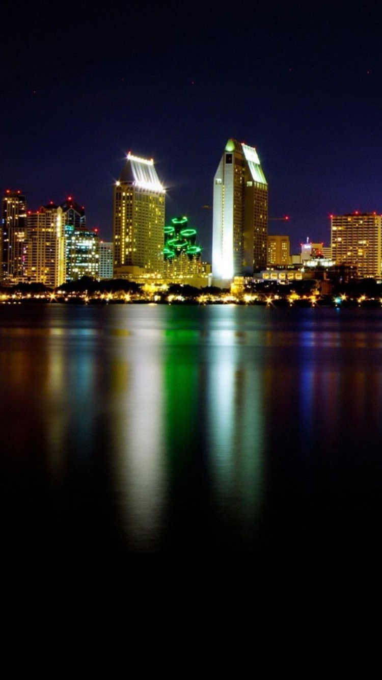 City Skyline Across Body of Water During Night Time. Wallpaper in 750x1334 Resolution