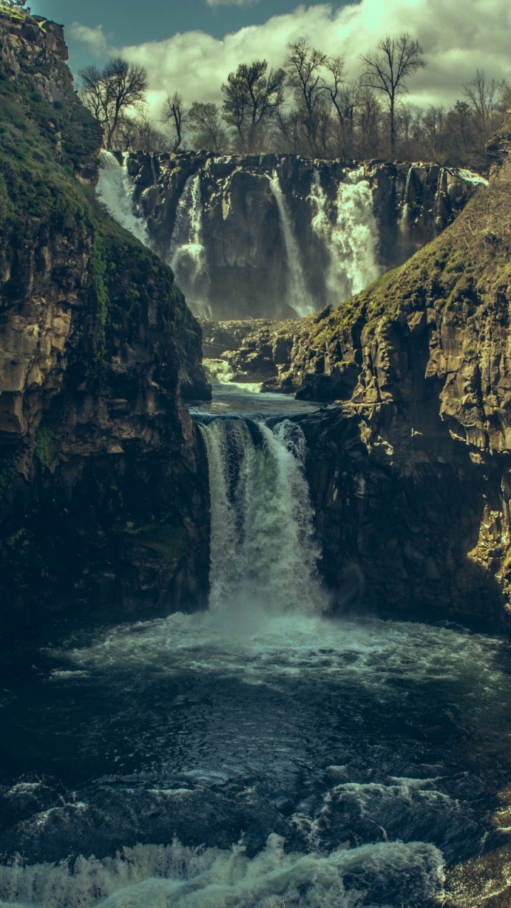 Waterfalls Between Brown Rocky Mountain During Daytime. Wallpaper in 720x1280 Resolution