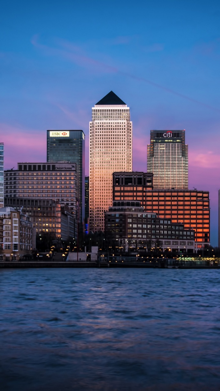 City Skyline Across Body of Water During Night Time. Wallpaper in 720x1280 Resolution