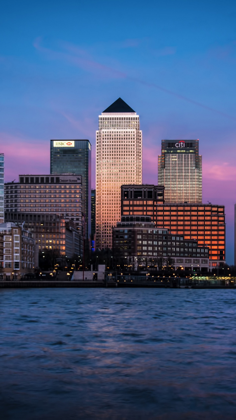 City Skyline Across Body of Water During Night Time. Wallpaper in 750x1334 Resolution