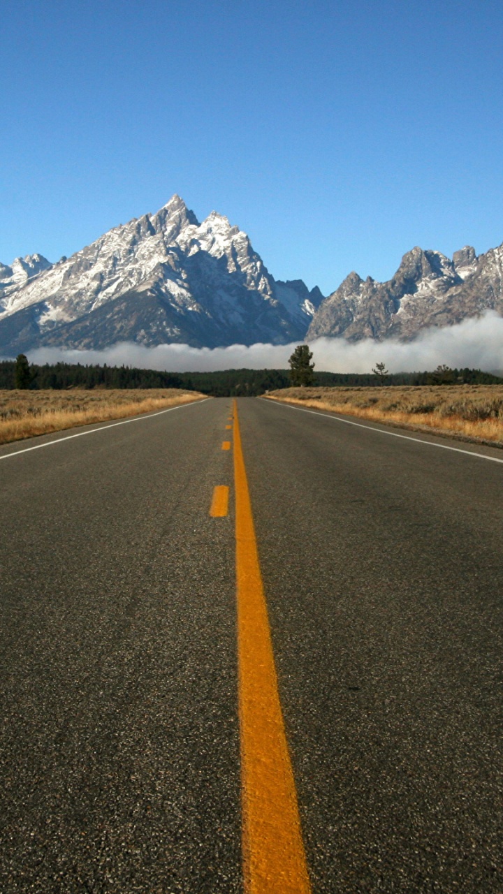 Gray Concrete Road Near Mountain Under Blue Sky During Daytime. Wallpaper in 720x1280 Resolution