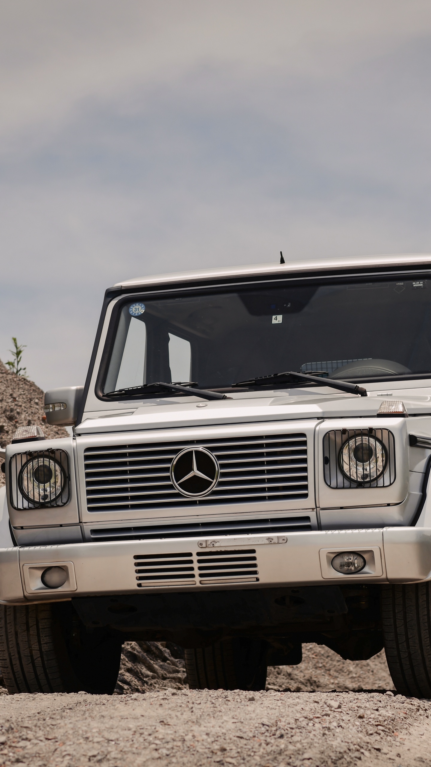White Jeep Wrangler on Brown Rocky Field Under White Cloudy Sky During Daytime. Wallpaper in 1440x2560 Resolution