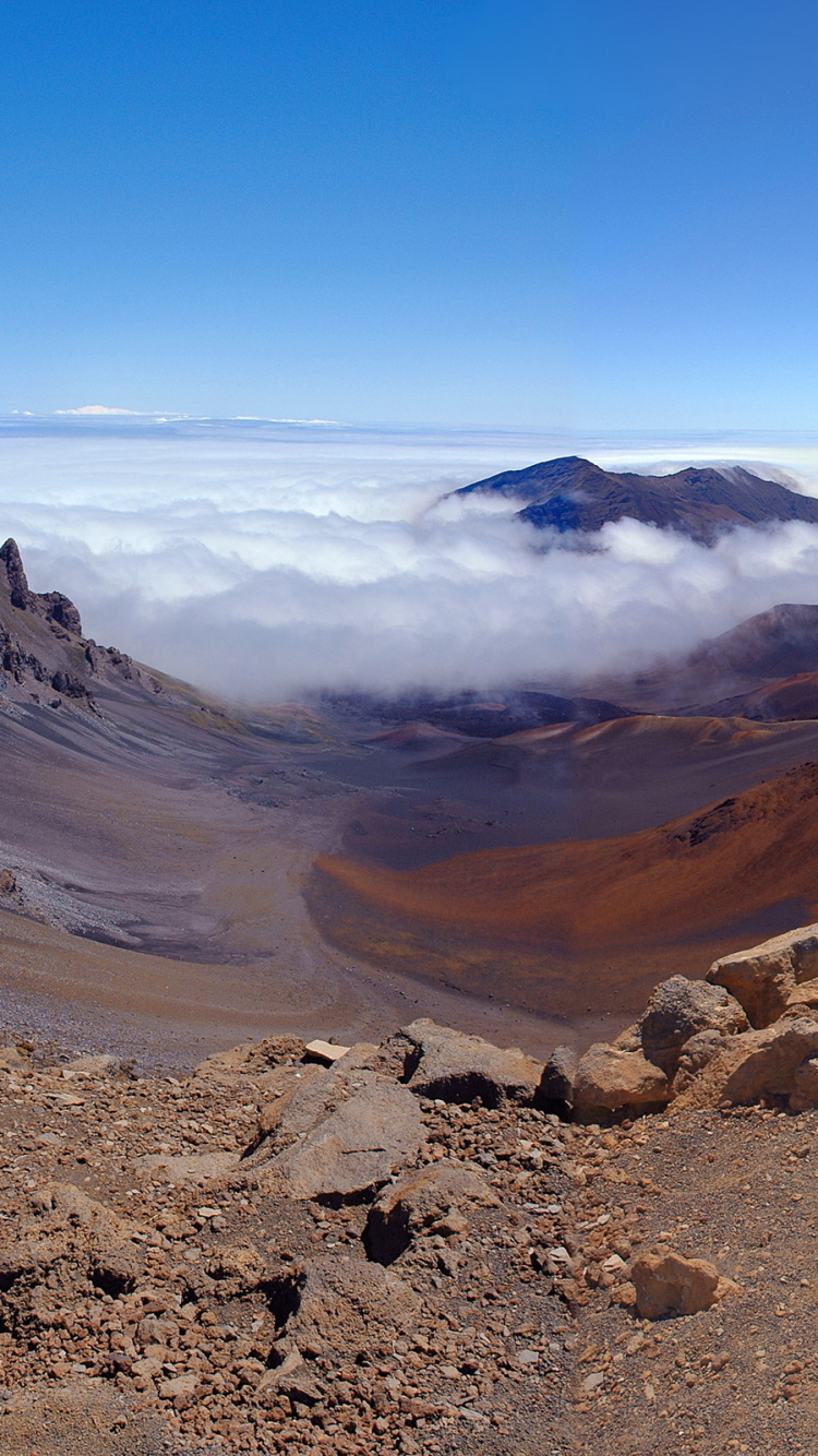 Brown Rocky Mountain Under Blue Sky During Daytime. Wallpaper in 750x1334 Resolution