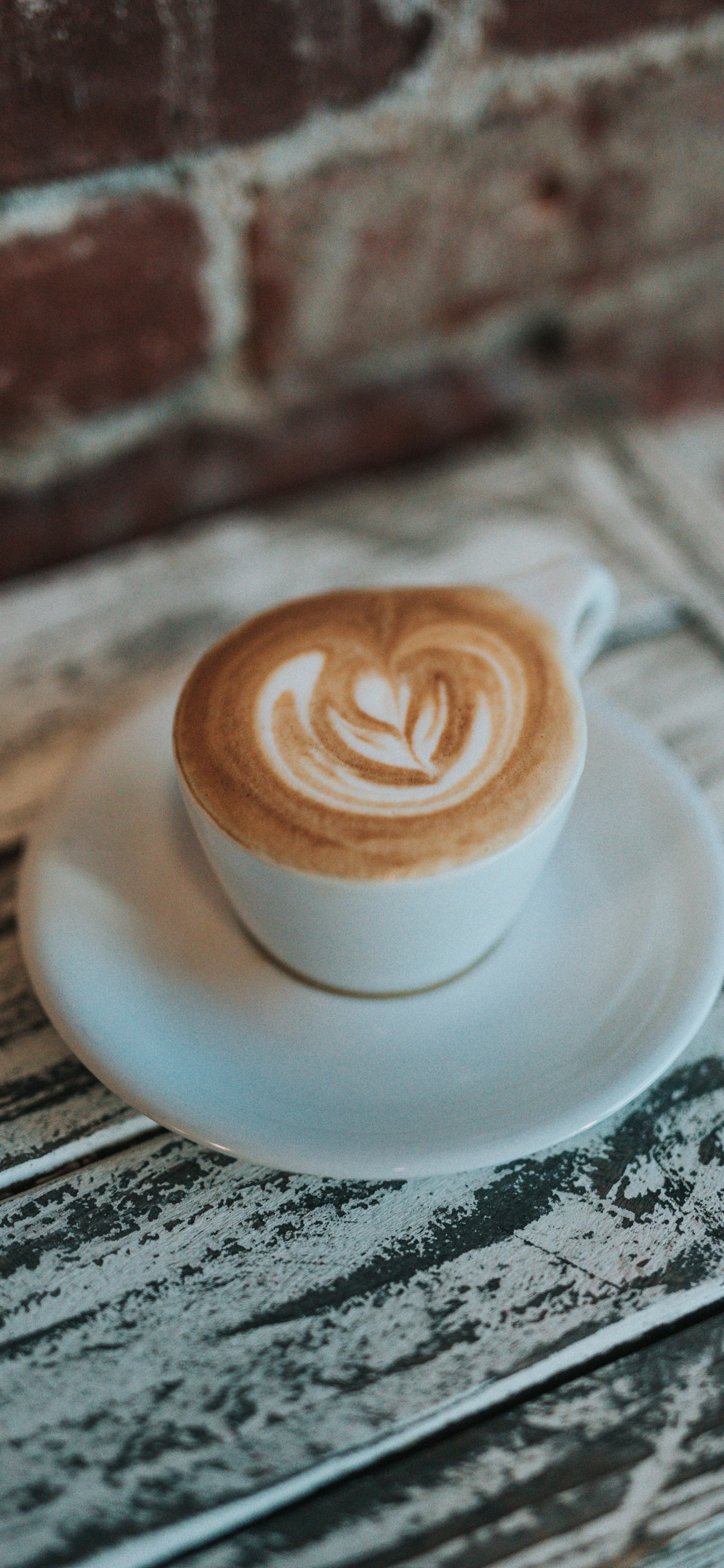 White Ceramic Cup With Saucer on Table. Wallpaper in 1125x2436 Resolution