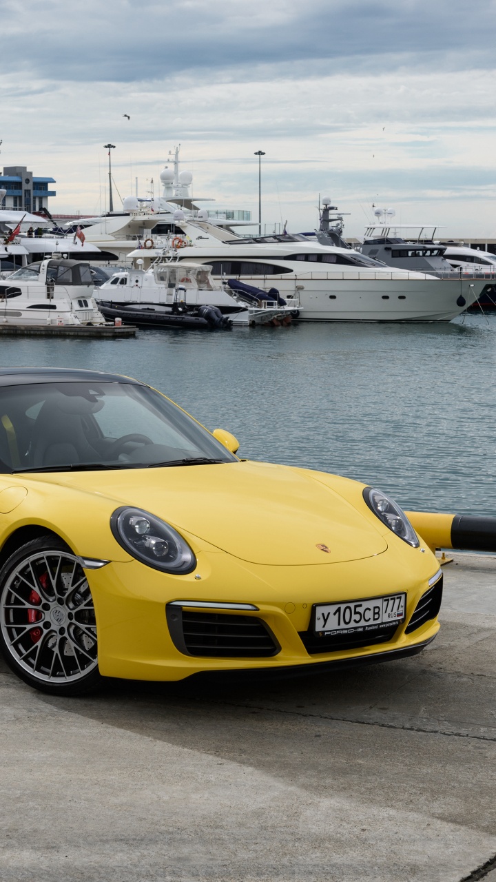 Yellow Ferrari 458 Italia Parked on Gray Concrete Pavement Near Body of Water During Daytime. Wallpaper in 720x1280 Resolution