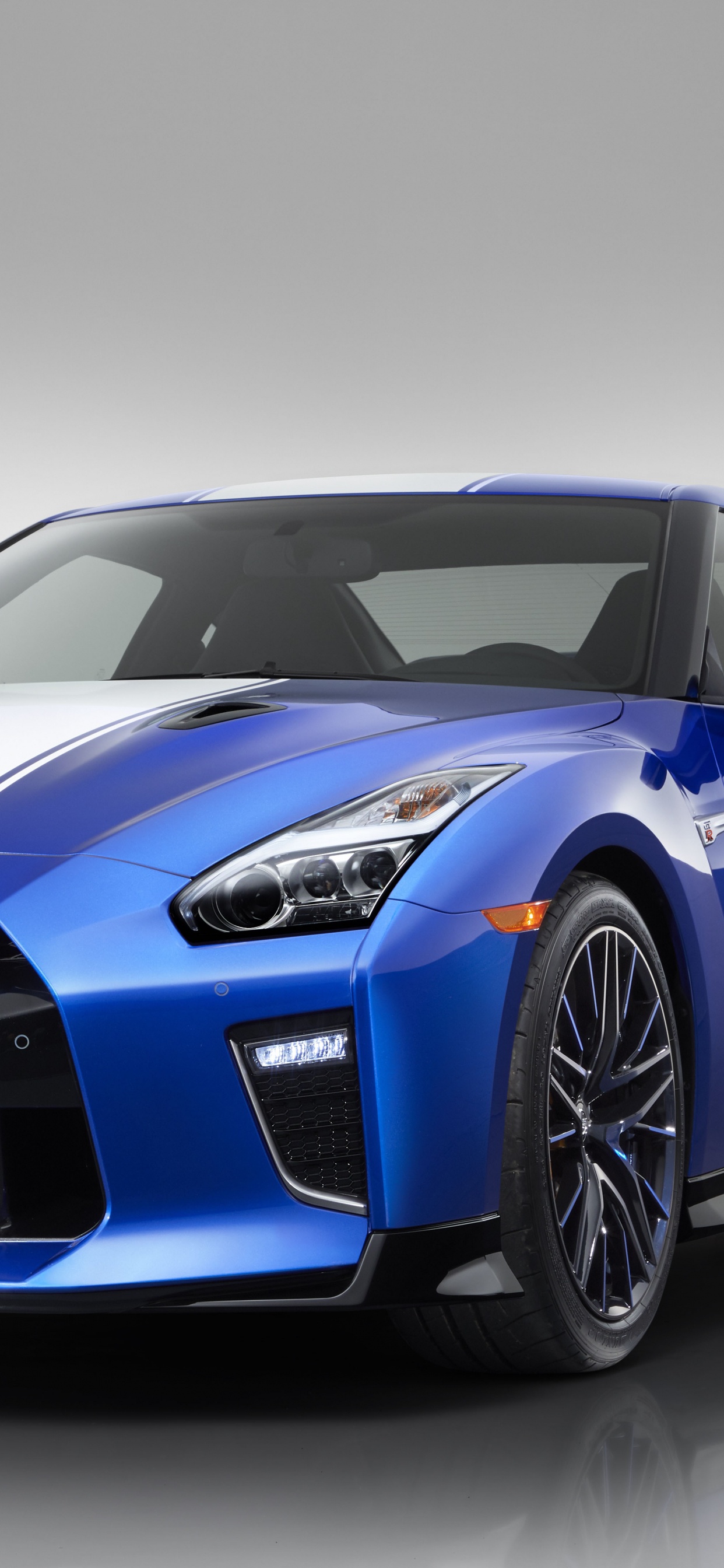 Blue Porsche 911 on White Background. Wallpaper in 1242x2688 Resolution