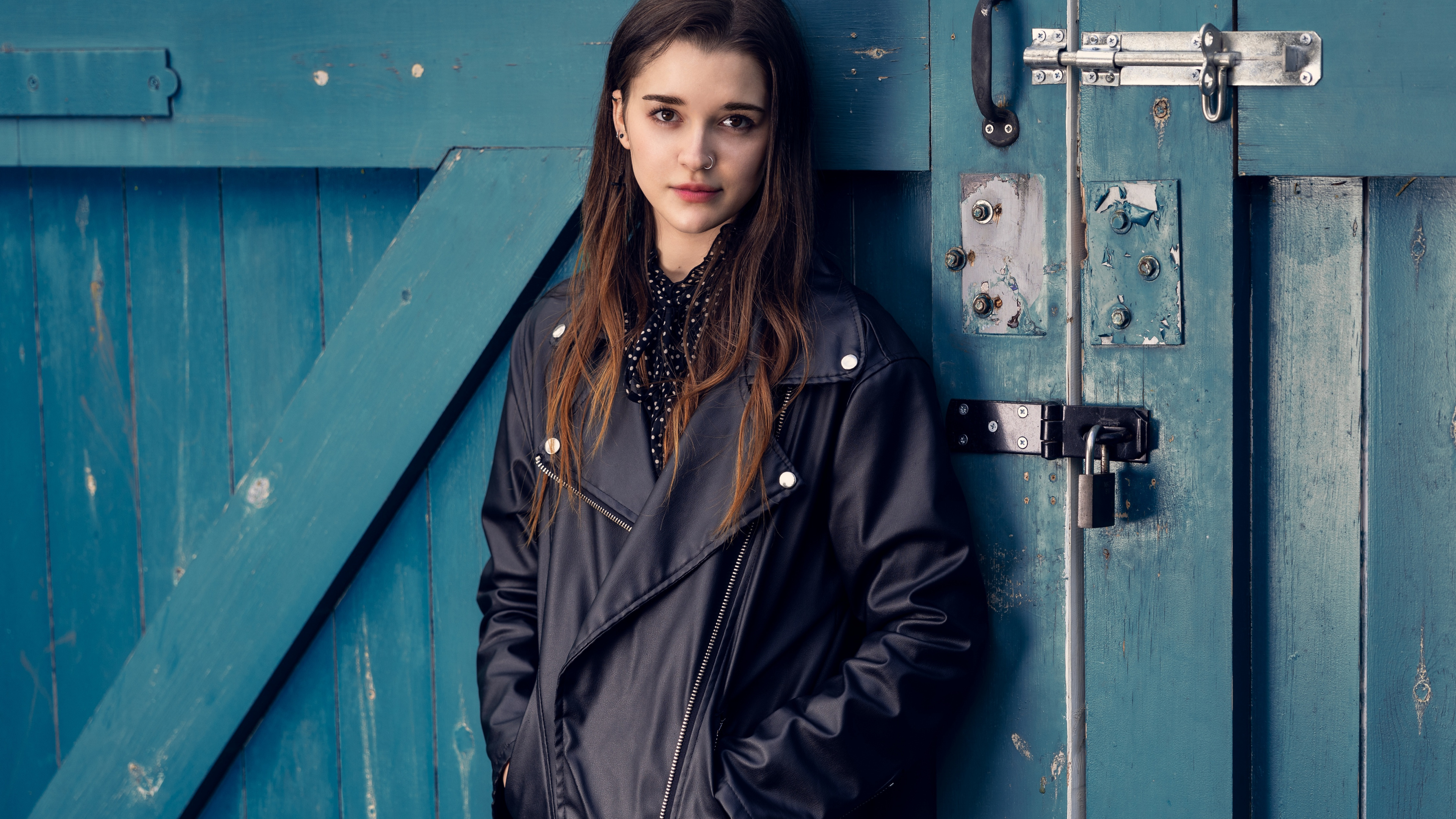 Woman in Black Coat Standing Beside Blue Wooden Door. Wallpaper in 3840x2160 Resolution