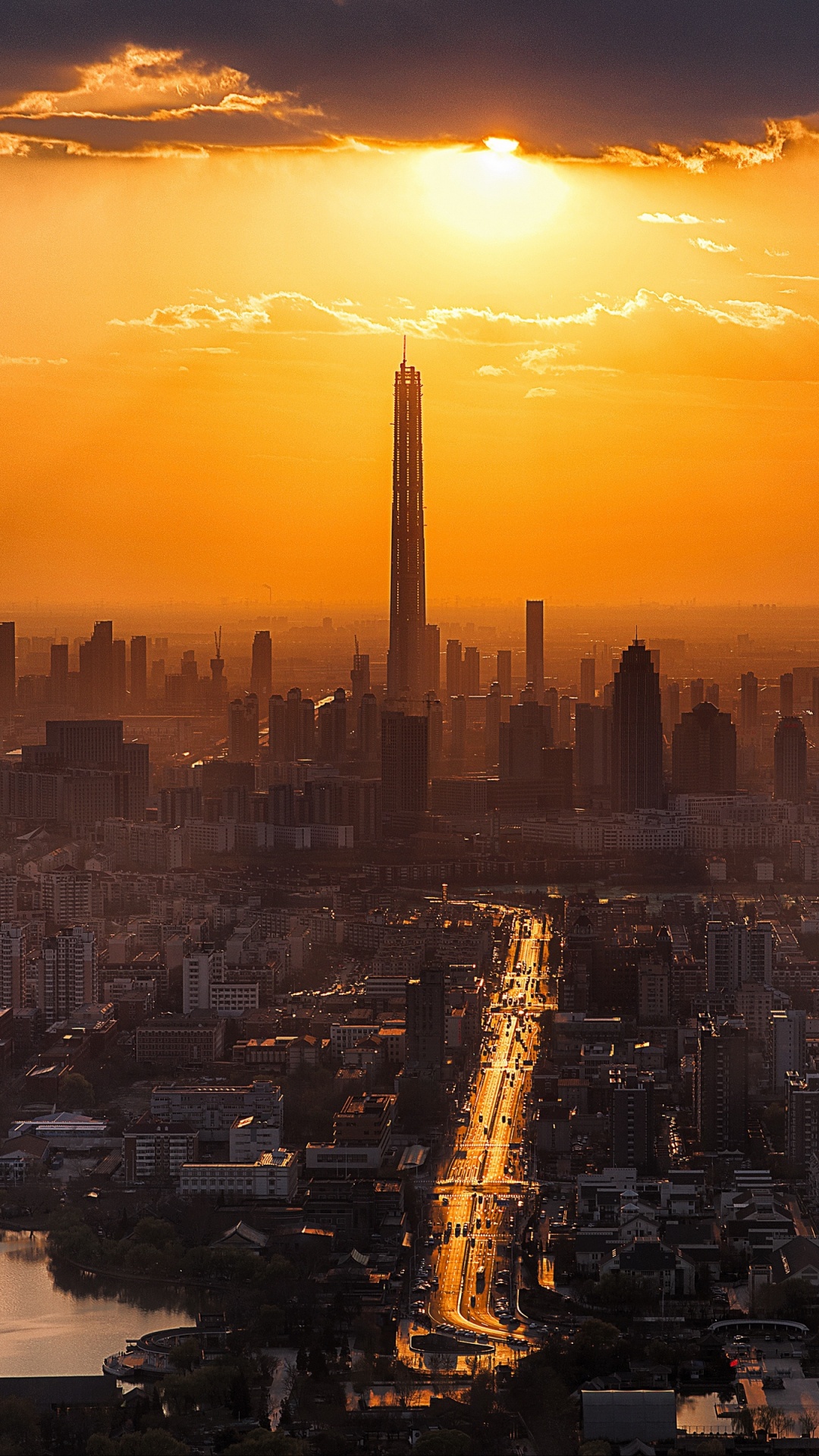 Horizonte de la Ciudad Durante la Puesta de Sol Con Cuerpo de Agua. Wallpaper in 1080x1920 Resolution