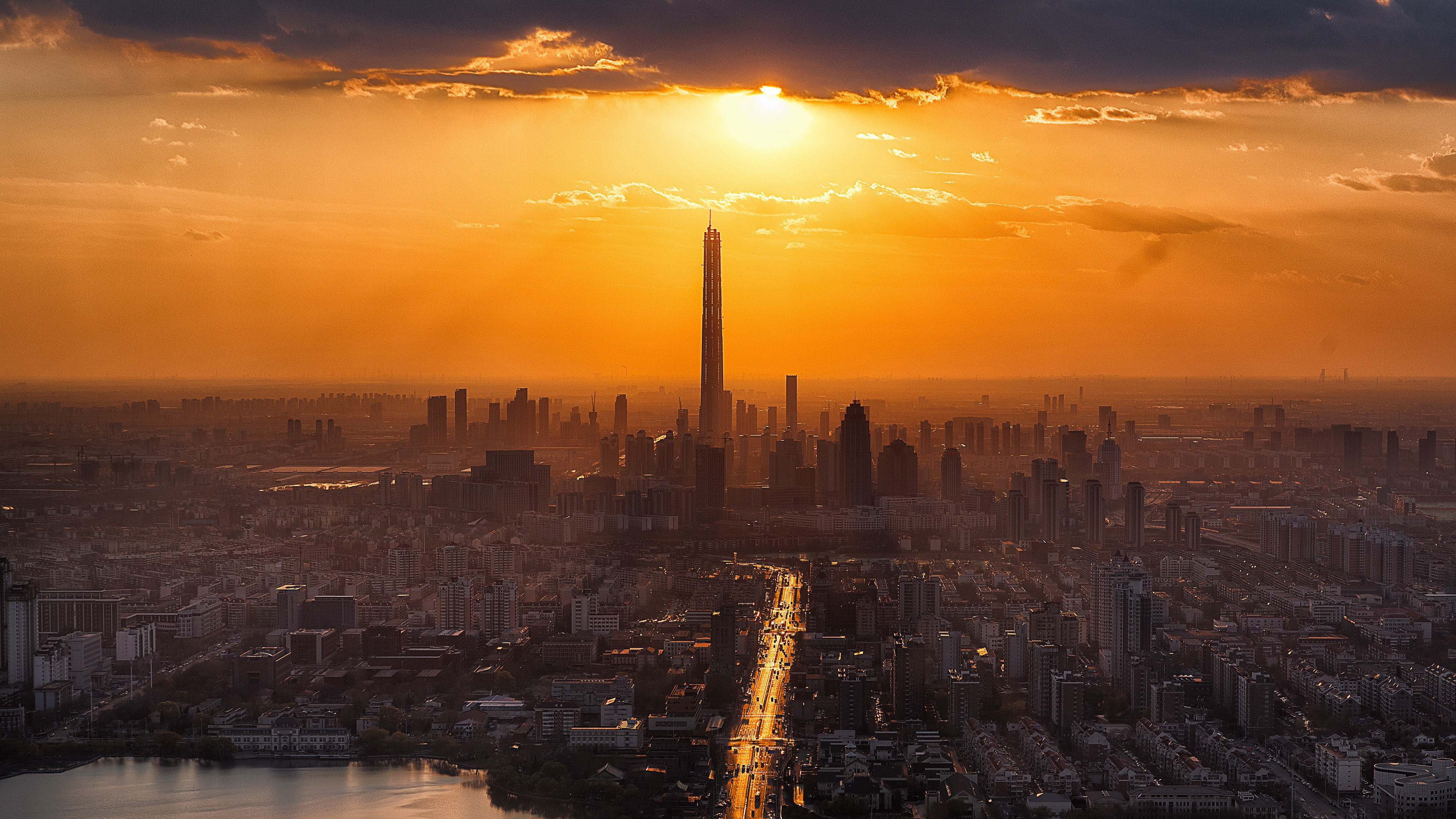 City Skyline During Sunset With Body of Water. Wallpaper in 3840x2160 Resolution