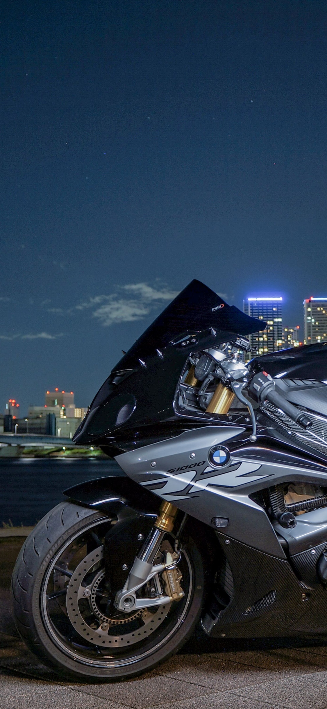 Black Sports Bike on Road During Night Time. Wallpaper in 1125x2436 Resolution