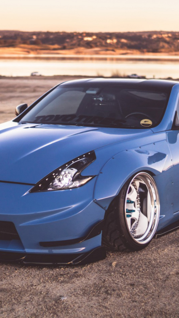 Blue Porsche 911 on Brown Sand During Daytime. Wallpaper in 750x1334 Resolution