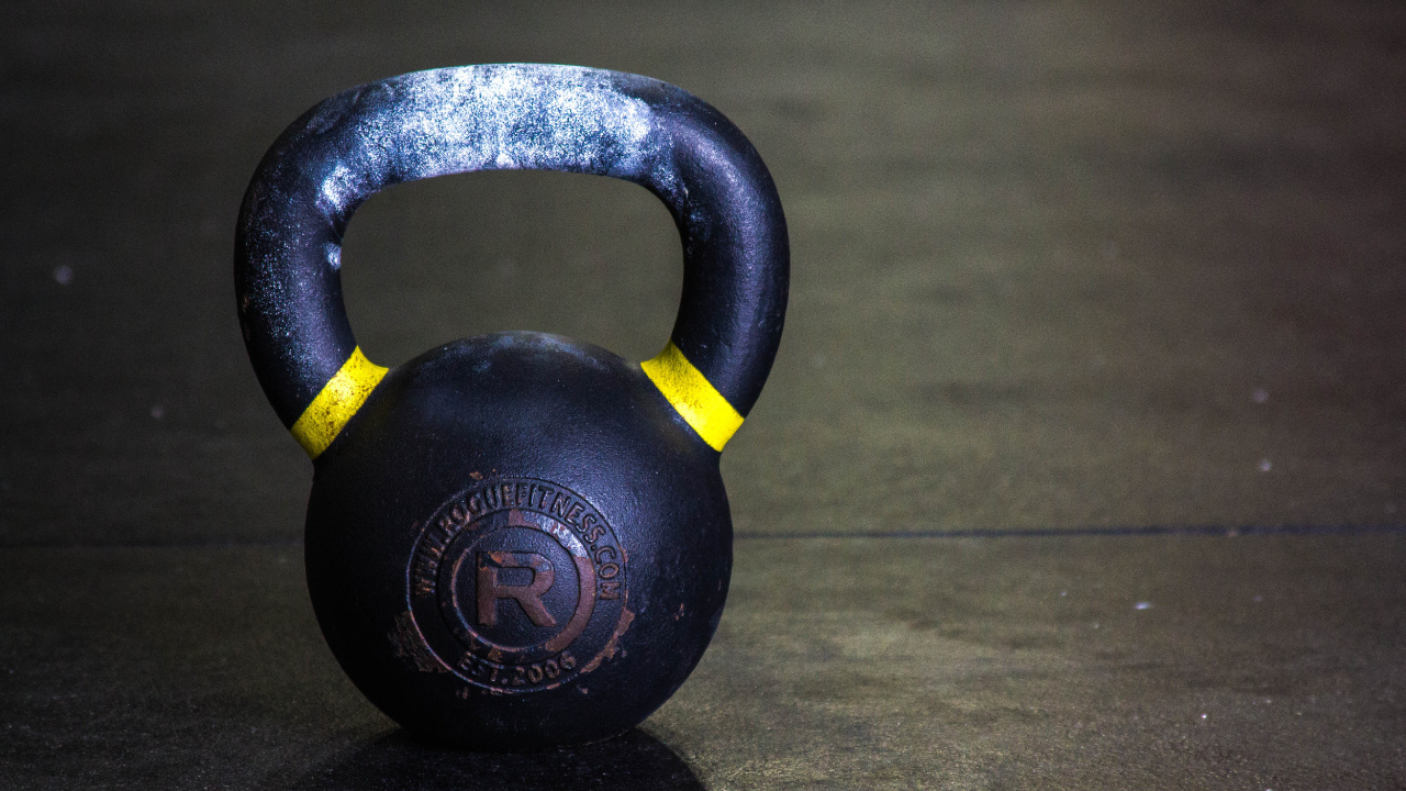 Black Kettle Bell on Brown Wooden Table. Wallpaper in 1280x720 Resolution