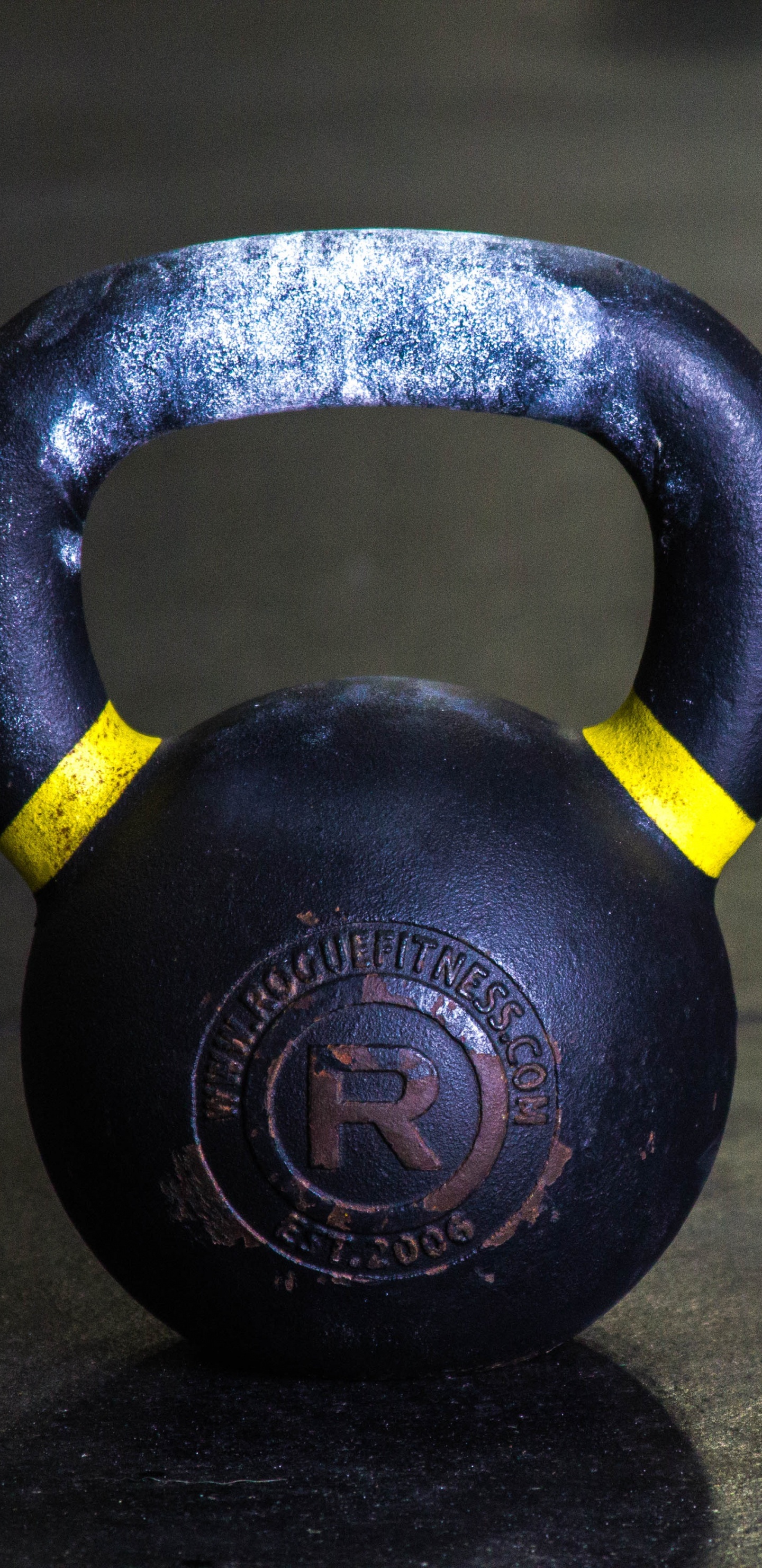 Black Kettle Bell on Brown Wooden Table. Wallpaper in 1440x2960 Resolution