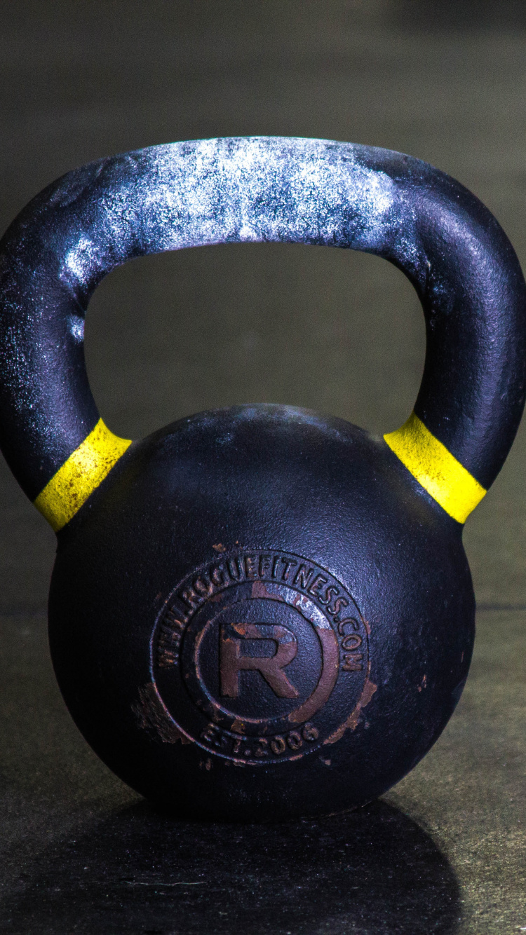 Black Kettle Bell on Brown Wooden Table. Wallpaper in 750x1334 Resolution