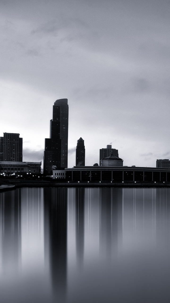 City Skyline Across Body of Water During Night Time. Wallpaper in 720x1280 Resolution