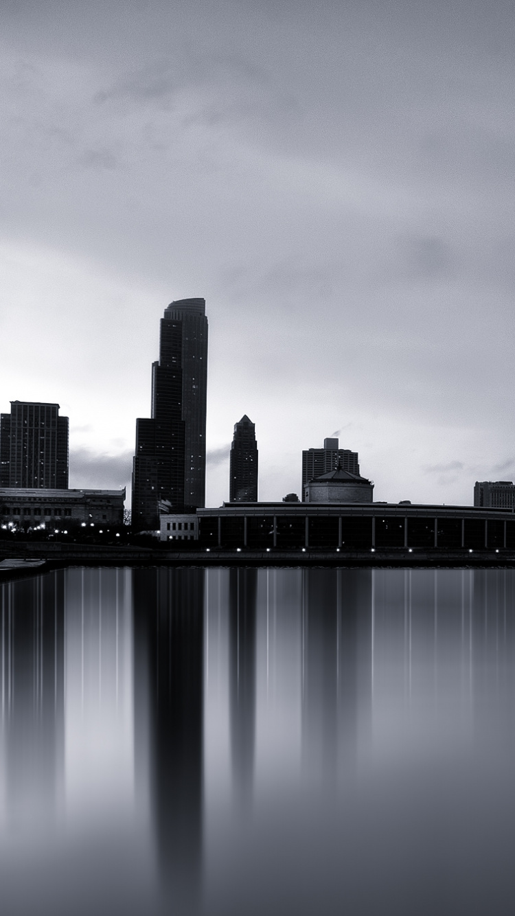 City Skyline Across Body of Water During Night Time. Wallpaper in 750x1334 Resolution
