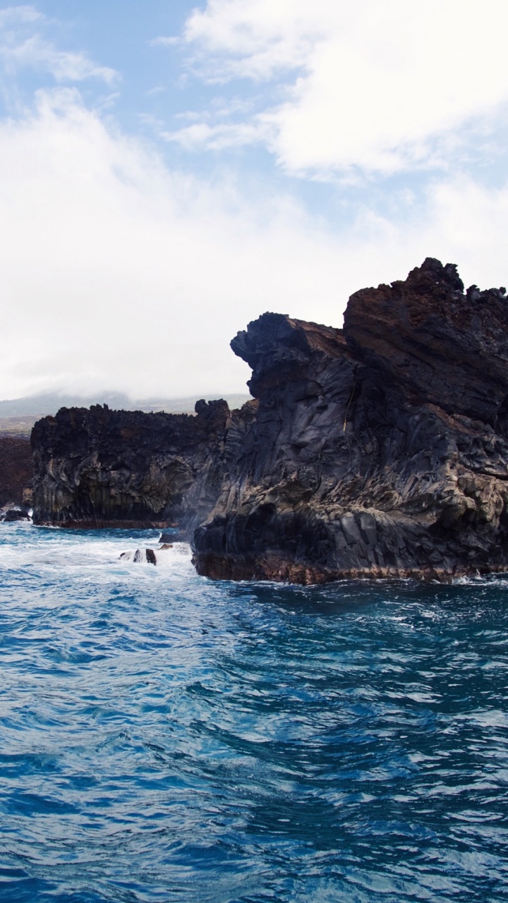 Brown and Green Rock Formation on Blue Sea Under White Clouds and Blue Sky During Daytime. Wallpaper in 720x1280 Resolution