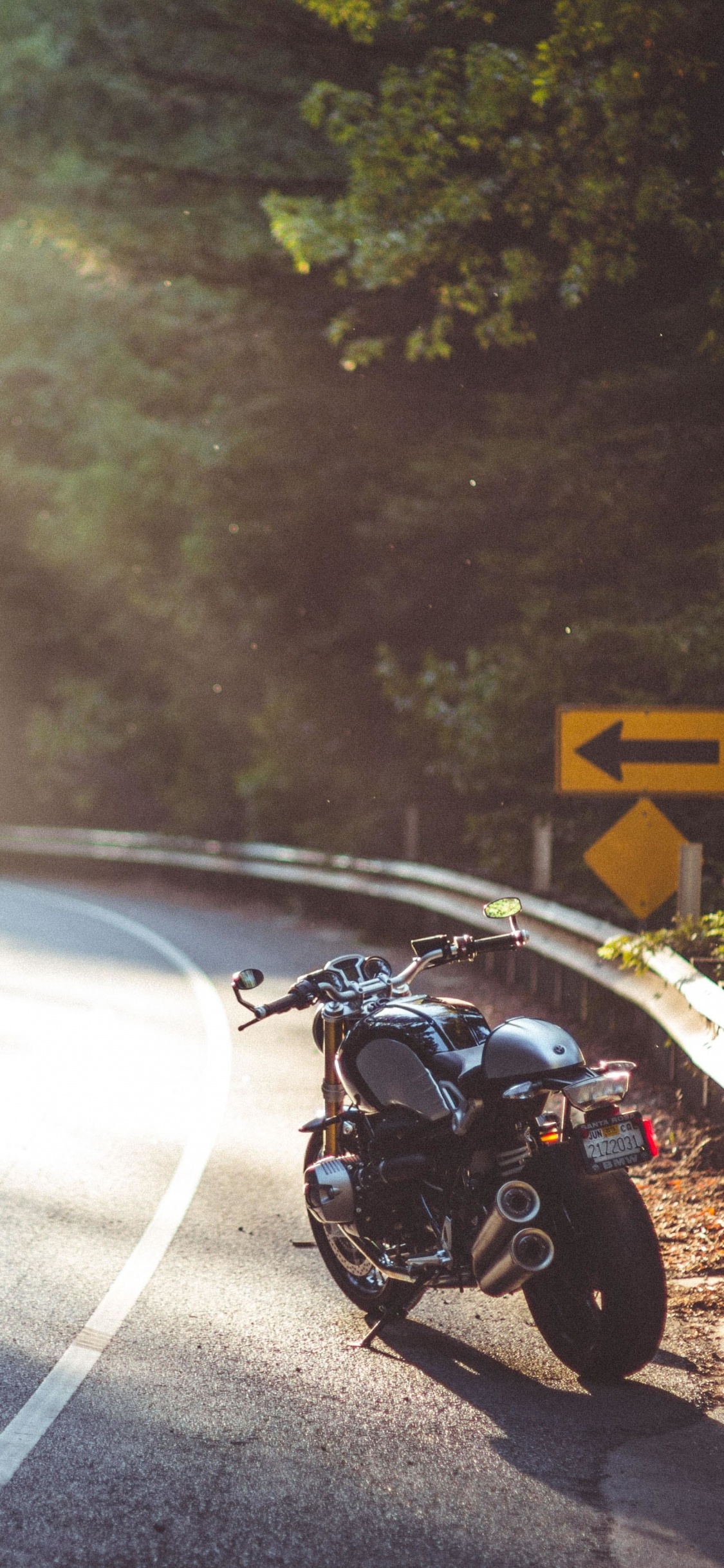 Black Motorcycle on Road During Daytime. Wallpaper in 1125x2436 Resolution