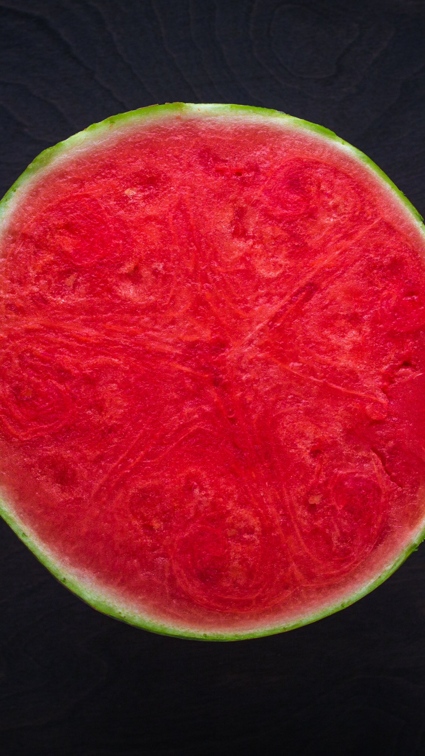 Sliced Watermelon on Black Wooden Table. Wallpaper in 1440x2560 Resolution
