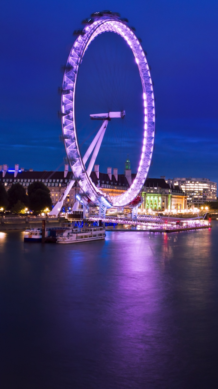 Riesenrad in Der Nähe Von Stadtgebäuden Während Der Nacht. Wallpaper in 720x1280 Resolution