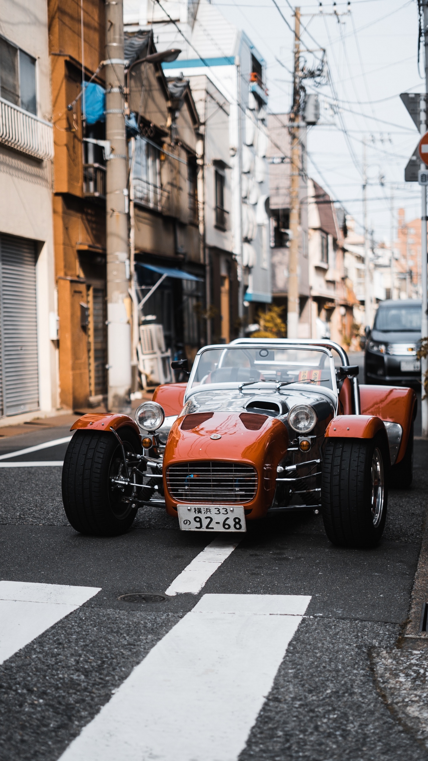 Orange and Black Car on Road During Daytime. Wallpaper in 1440x2560 Resolution