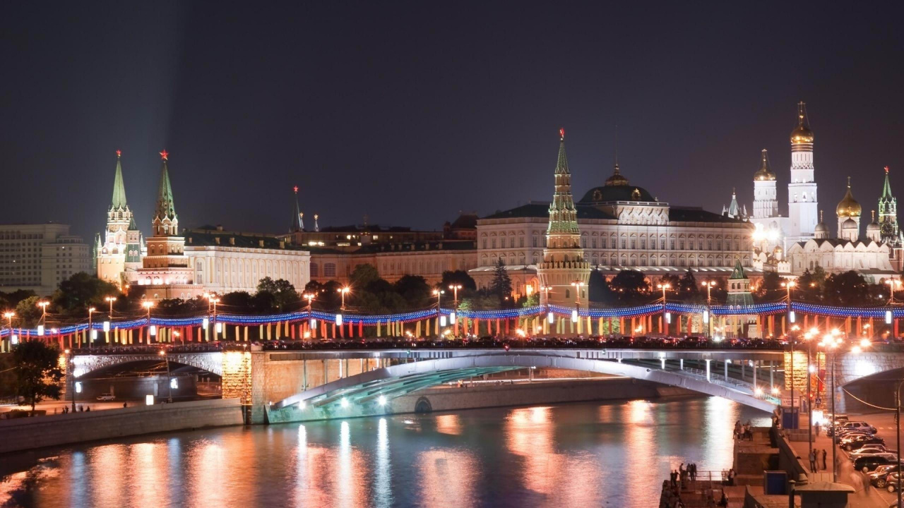 White Concrete Building Near Body of Water During Night Time. Wallpaper in 1280x720 Resolution