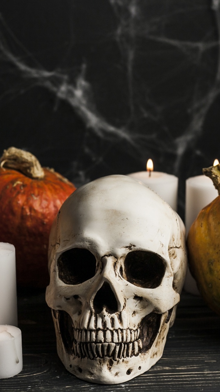 White Pillar Candles Beside Yellow and Red Round Fruit. Wallpaper in 720x1280 Resolution