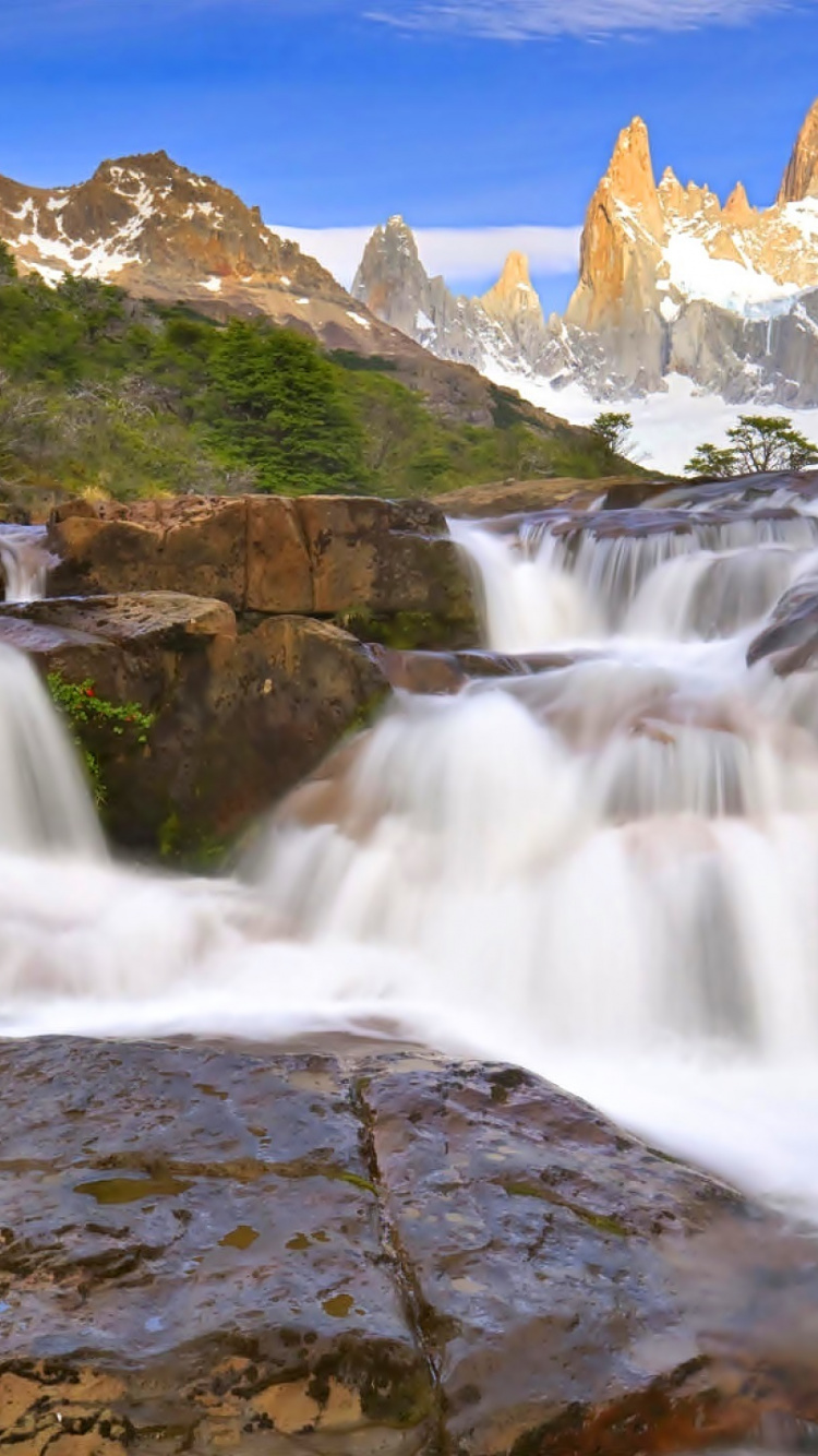 Waterfalls Near Green Grass Field During Daytime. Wallpaper in 750x1334 Resolution