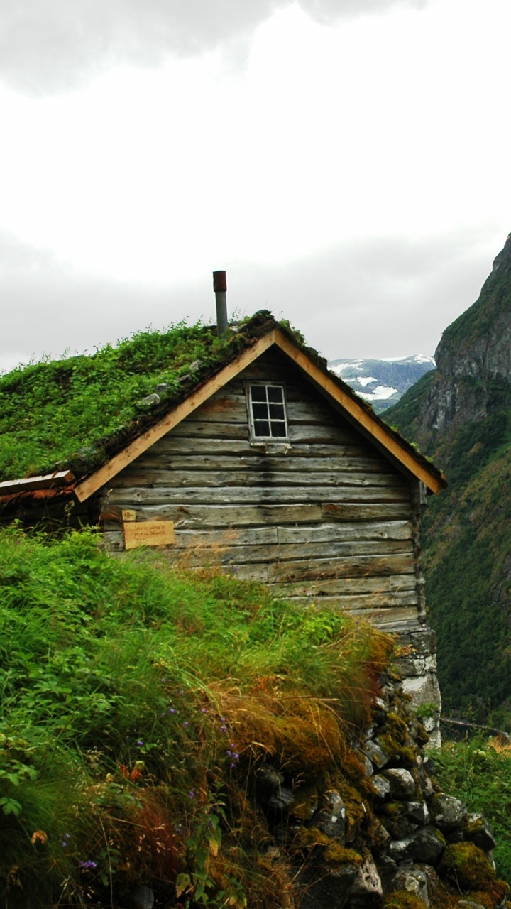 Brown Wooden House on Green Grass Field Near Mountain During Daytime. Wallpaper in 720x1280 Resolution