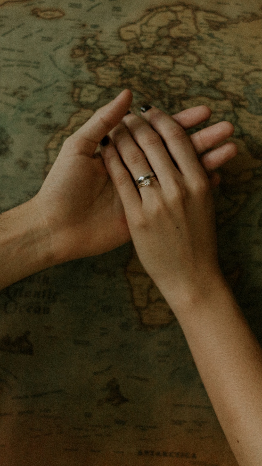 Persons Left Hand on Brown Wooden Surface. Wallpaper in 1080x1920 Resolution