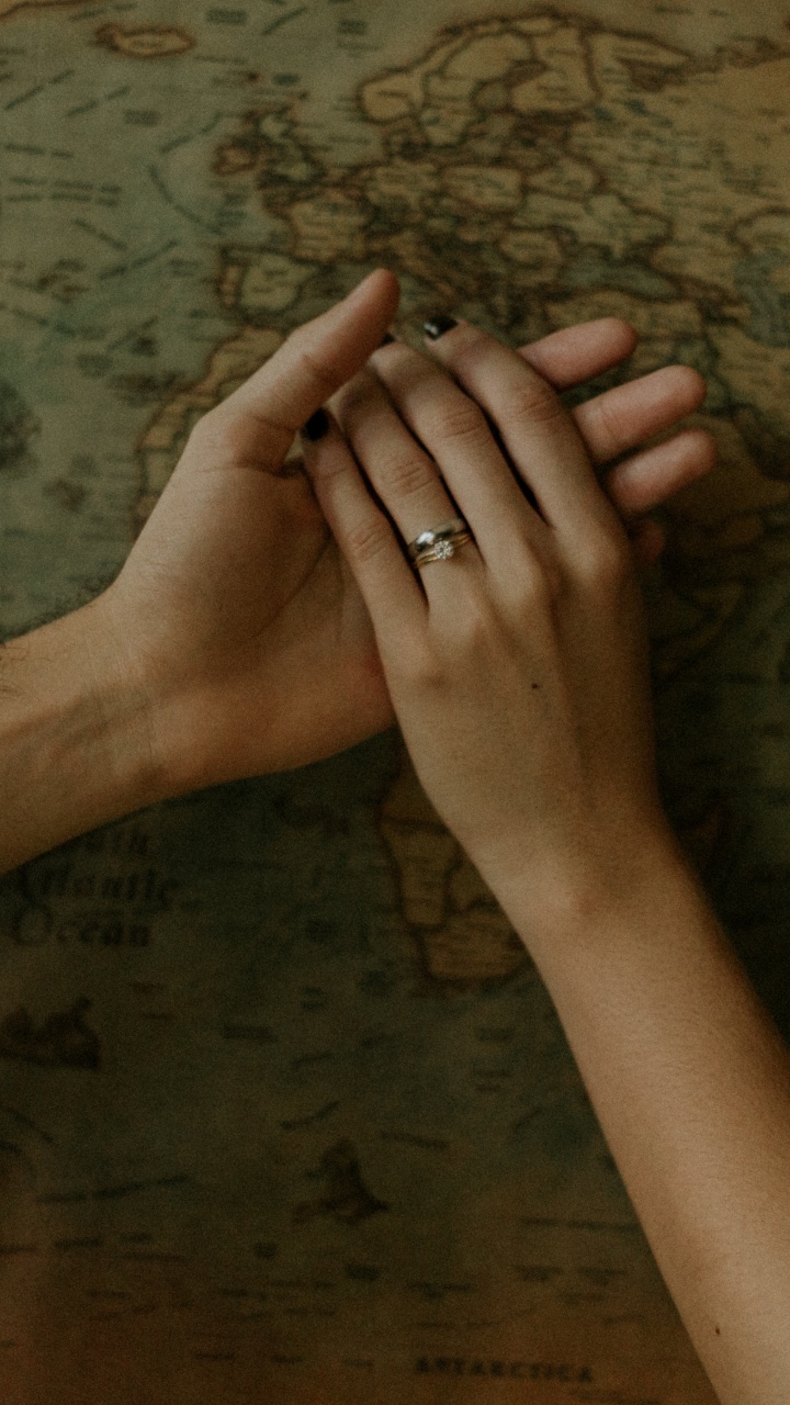 Persons Left Hand on Brown Wooden Surface. Wallpaper in 720x1280 Resolution