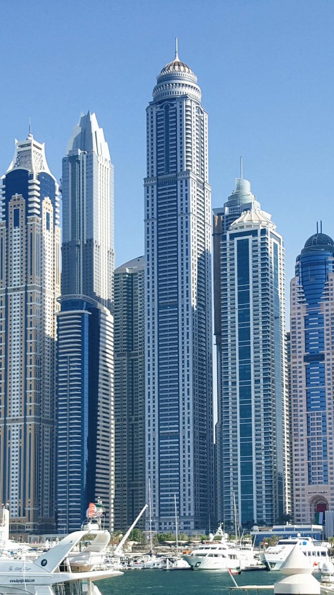 White and Blue High Rise Buildings Near Body of Water During Daytime. Wallpaper in 1080x1920 Resolution