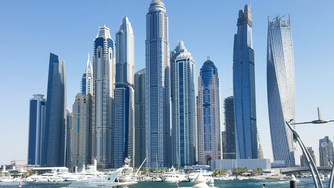 White and Blue High Rise Buildings Near Body of Water During Daytime. Wallpaper in 1366x768 Resolution