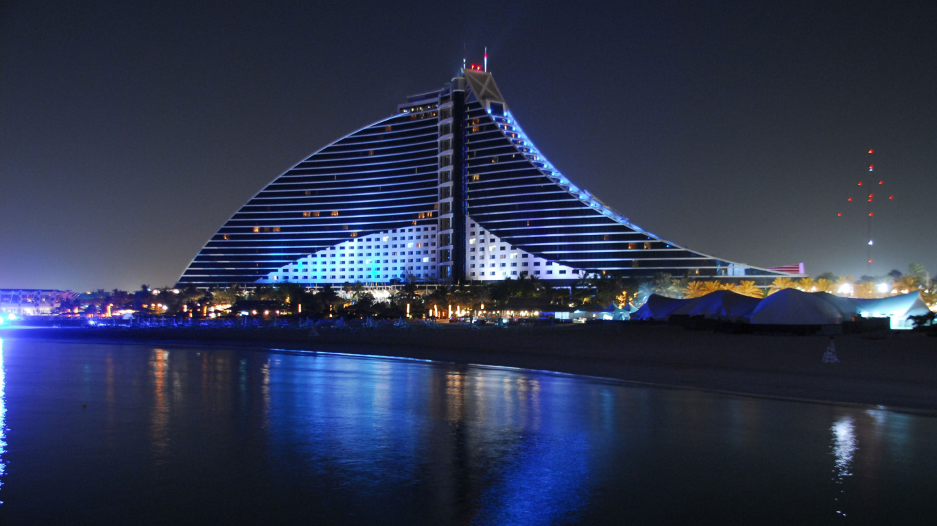 Lighted Bridge Over Body of Water During Night Time. Wallpaper in 1366x768 Resolution