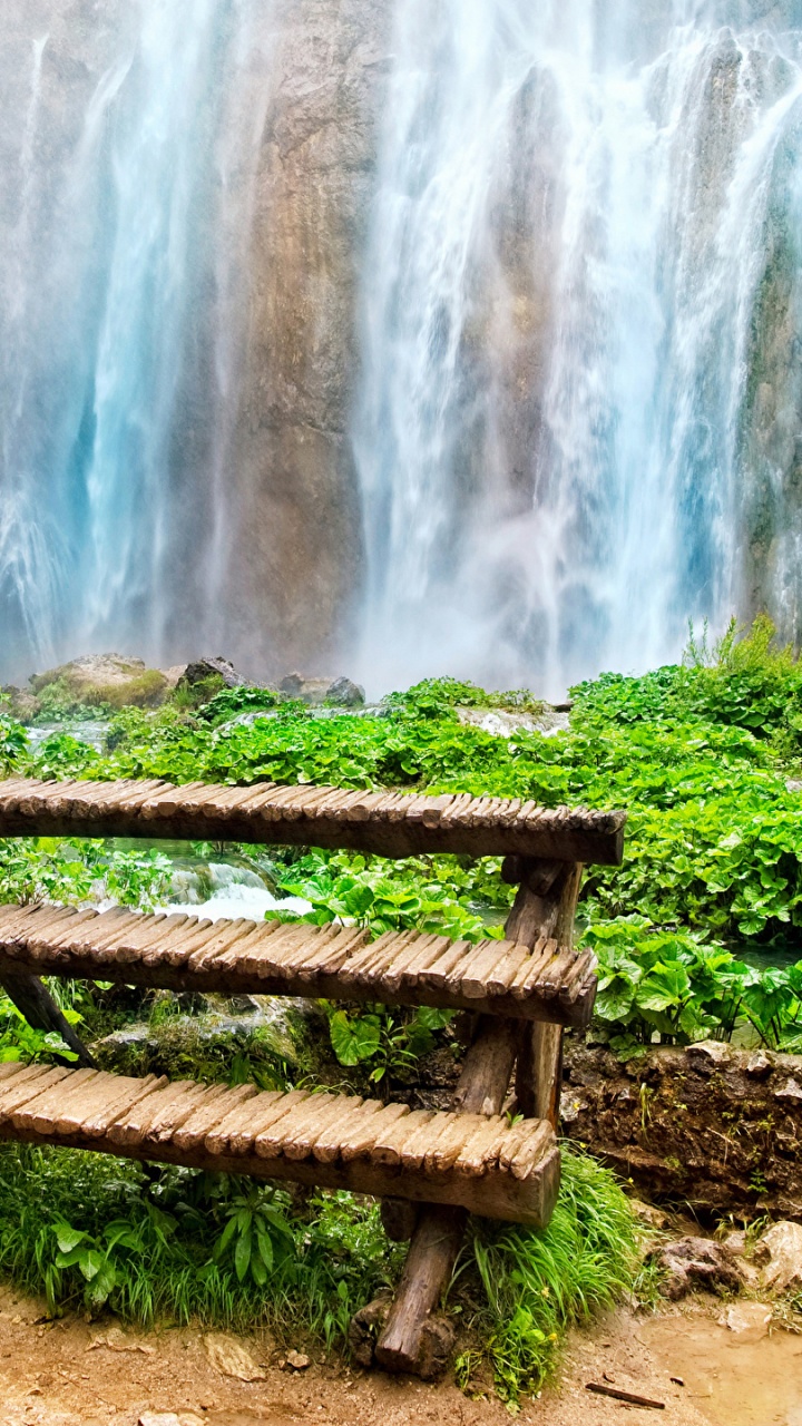 Brown Wooden Bench Near Waterfalls During Daytime. Wallpaper in 720x1280 Resolution