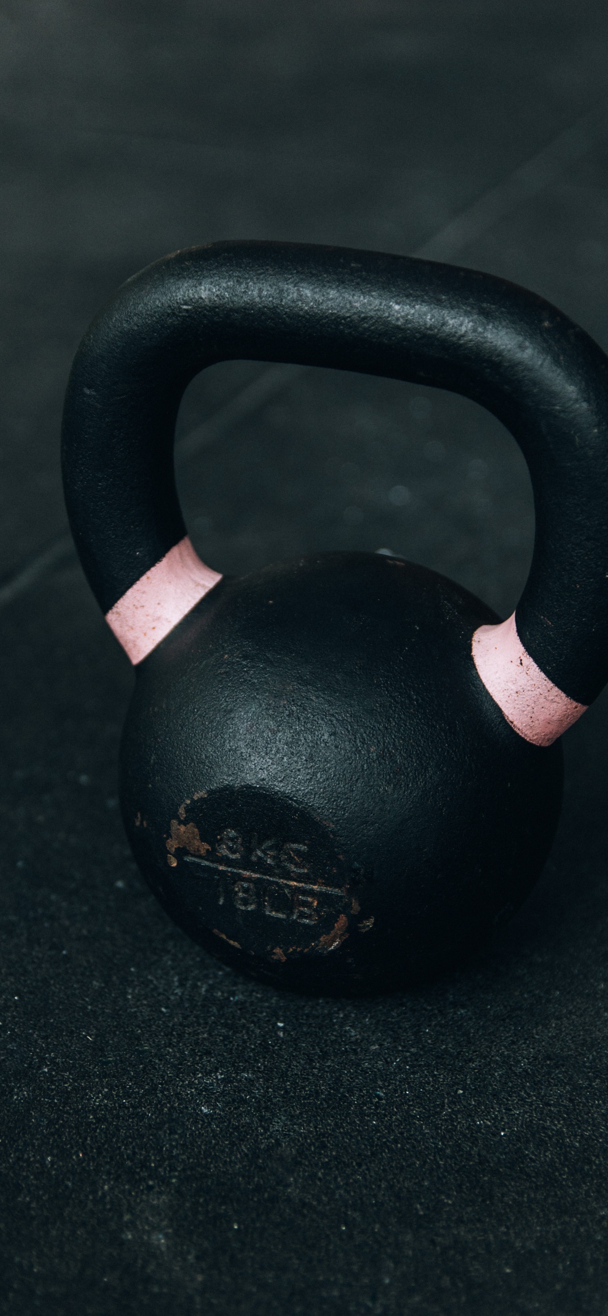 Black Kettle Bell on Black Table. Wallpaper in 1242x2688 Resolution