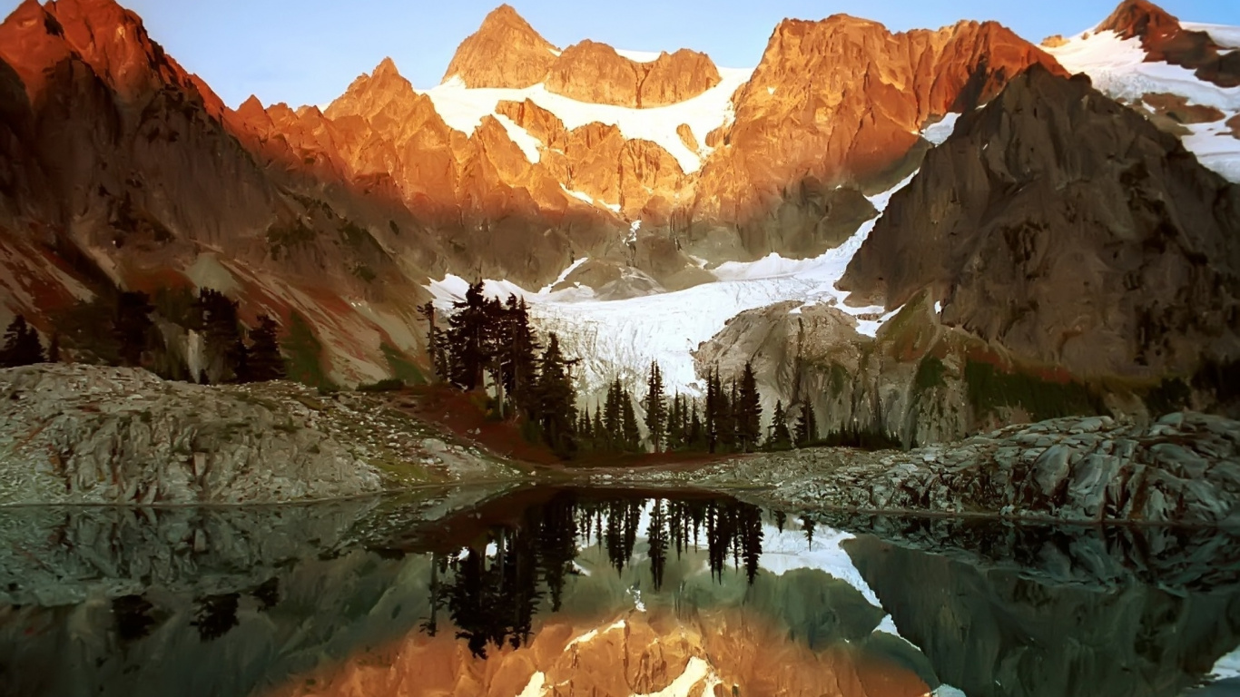 Brown and White Mountains Near Green Trees and Lake During Daytime. Wallpaper in 1366x768 Resolution