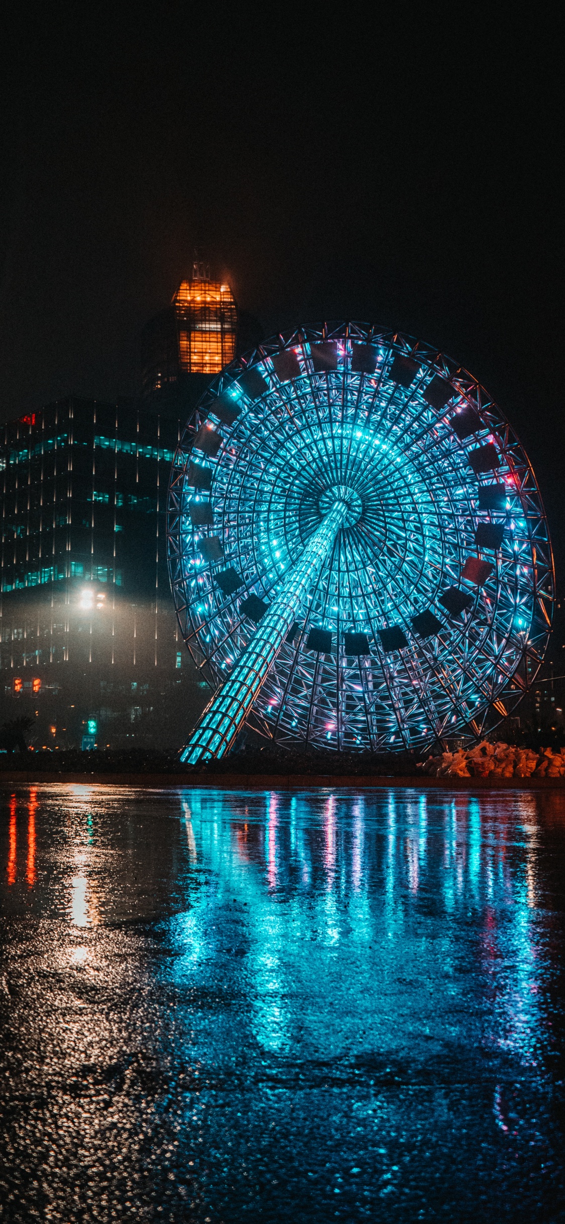 Blue and White Ferris Wheel During Night Time. Wallpaper in 1125x2436 Resolution
