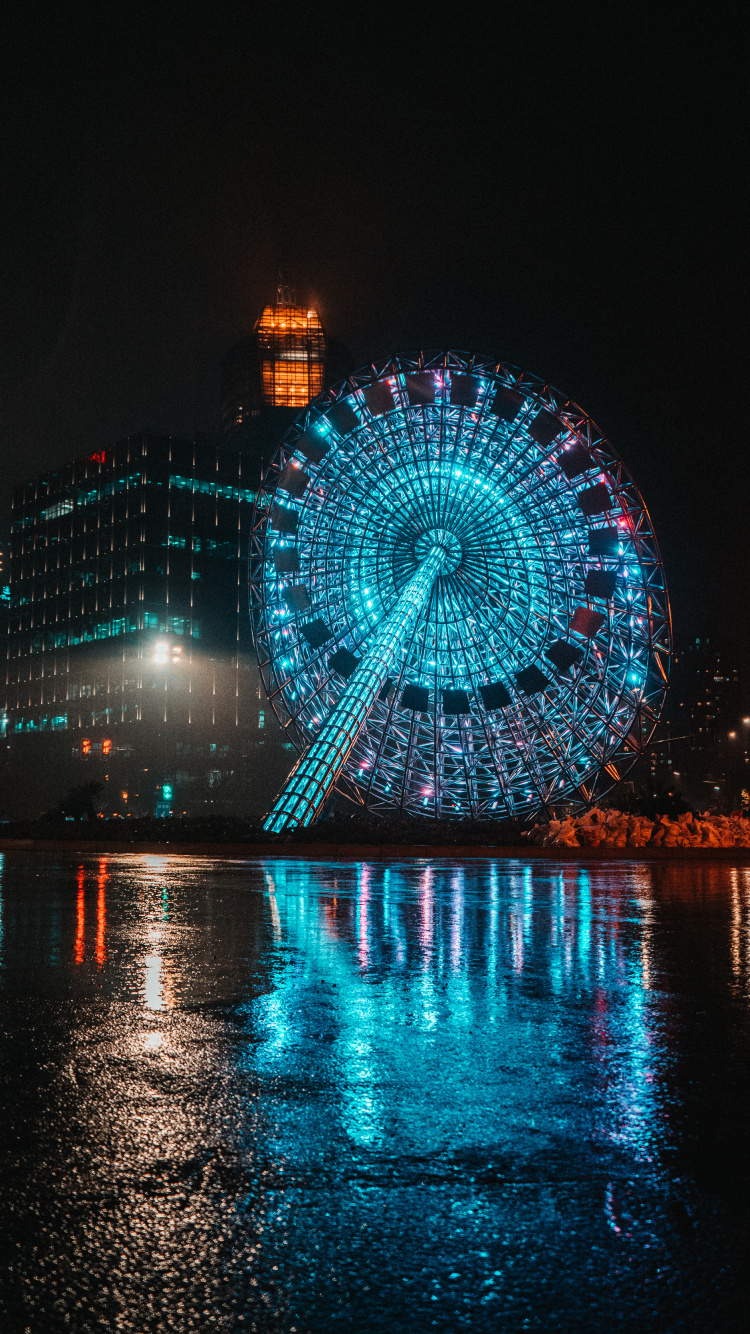 Blue and White Ferris Wheel During Night Time. Wallpaper in 750x1334 Resolution