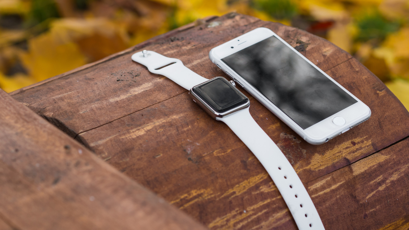 White Iphone 5 on Brown Wooden Table. Wallpaper in 1366x768 Resolution