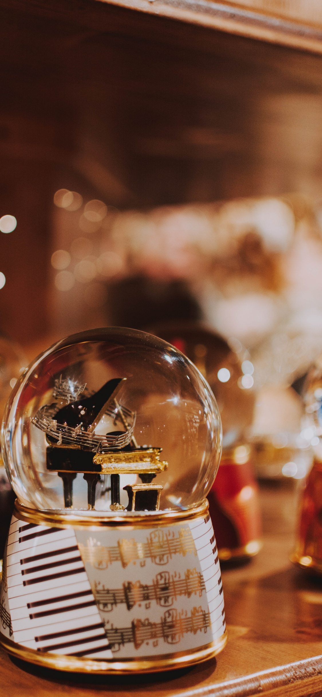 Clear Glass Ball on Table. Wallpaper in 1125x2436 Resolution