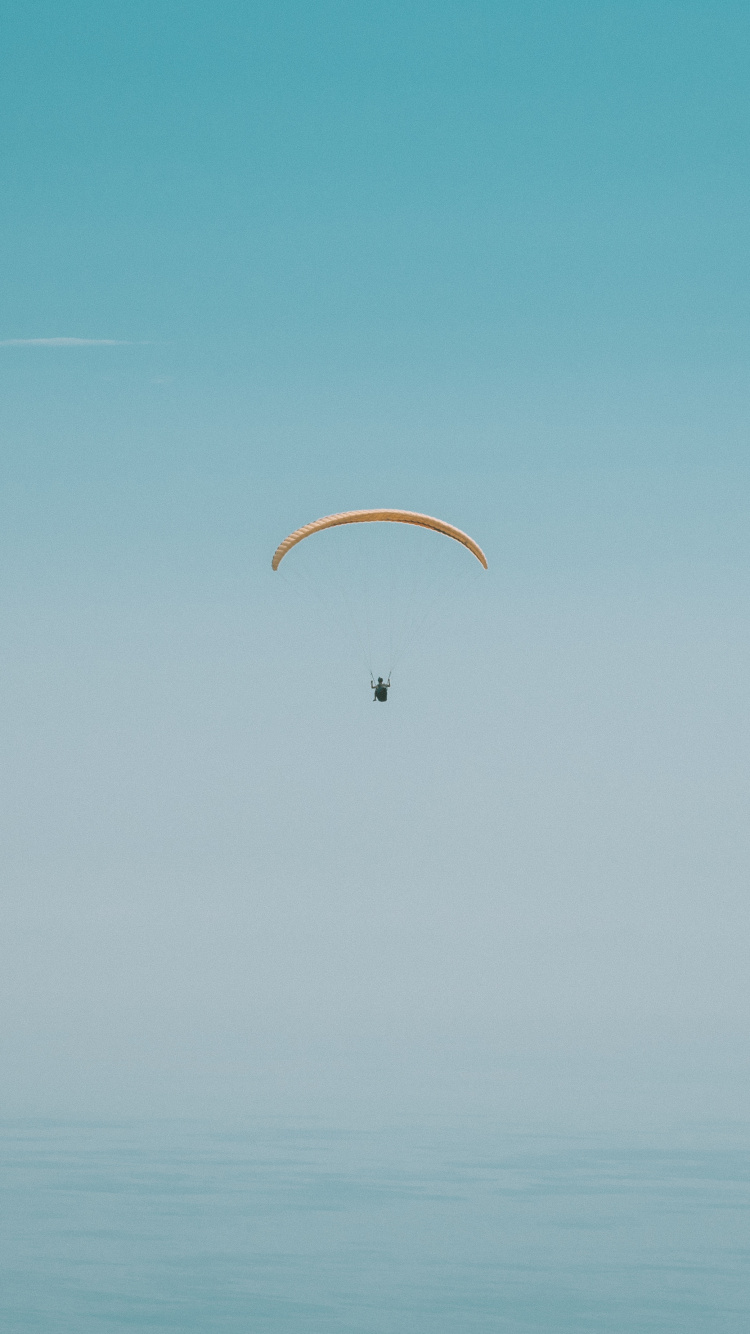 Person in Parachute Under Blue Sky During Daytime. Wallpaper in 750x1334 Resolution