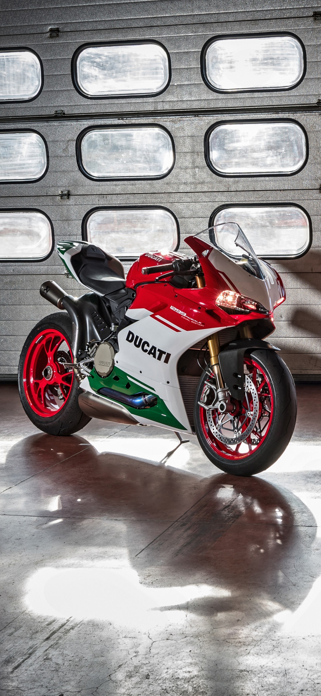 Red and Black Sports Bike Parked Beside White and Brown Concrete Building During Daytime. Wallpaper in 1125x2436 Resolution