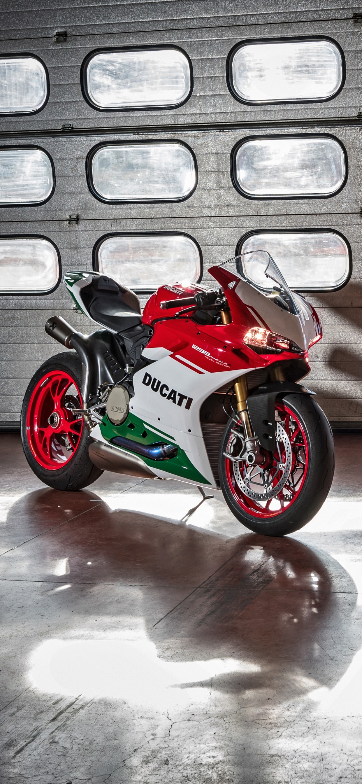 Red and Black Sports Bike Parked Beside White and Brown Concrete Building During Daytime. Wallpaper in 1242x2688 Resolution