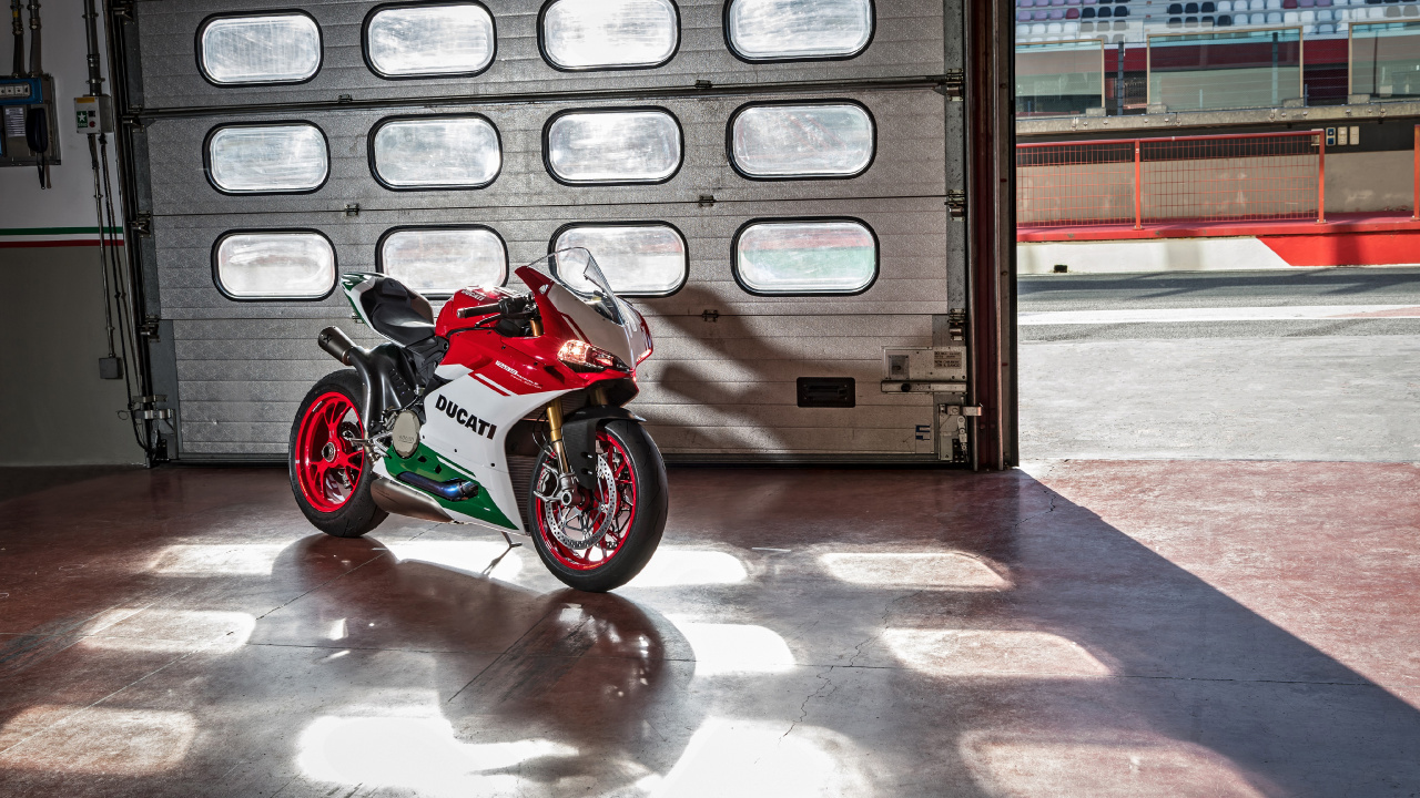 Red and Black Sports Bike Parked Beside White and Brown Concrete Building During Daytime. Wallpaper in 1280x720 Resolution