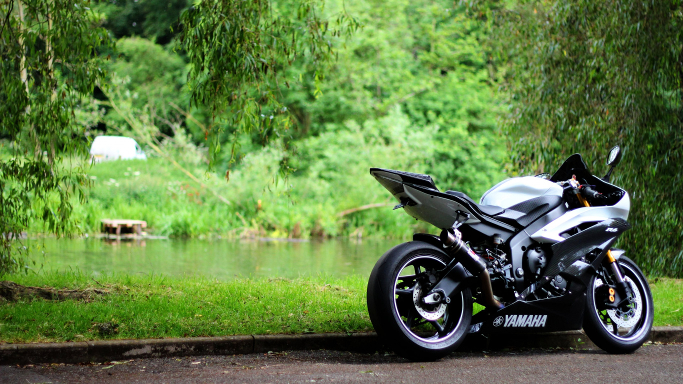 Black and White Sports Bike Parked Beside River During Daytime. Wallpaper in 1366x768 Resolution