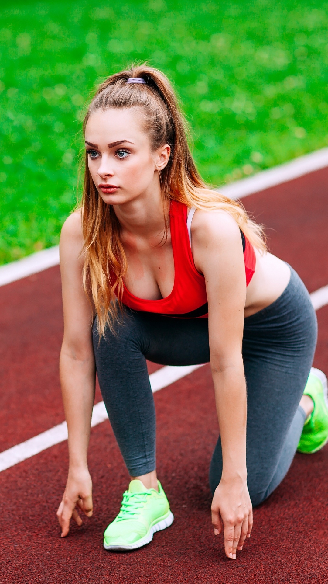 Woman in Black Tank Top and Green Shorts Running on Track Field During Daytime. Wallpaper in 1080x1920 Resolution